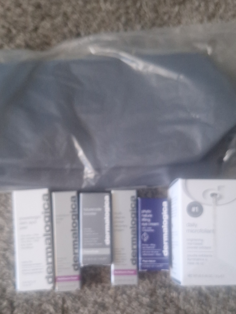 dermalogica travel skincare assortment with Charcoal Bag